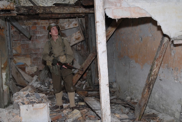 Young American soldier ww2 in the ruins