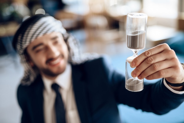 Young Arab businessman raised Hourglass up.