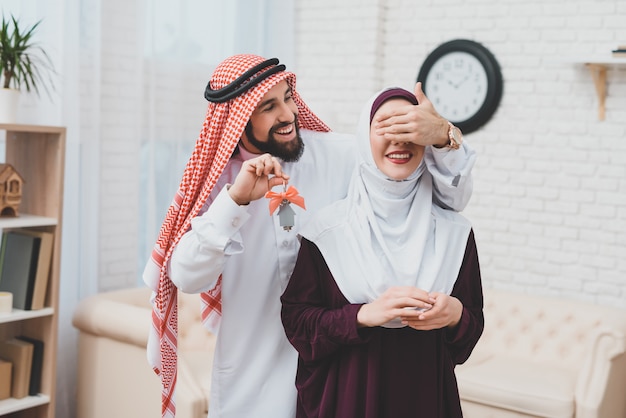 Young Arab Couple Moving Man Closes Eyes for Wife