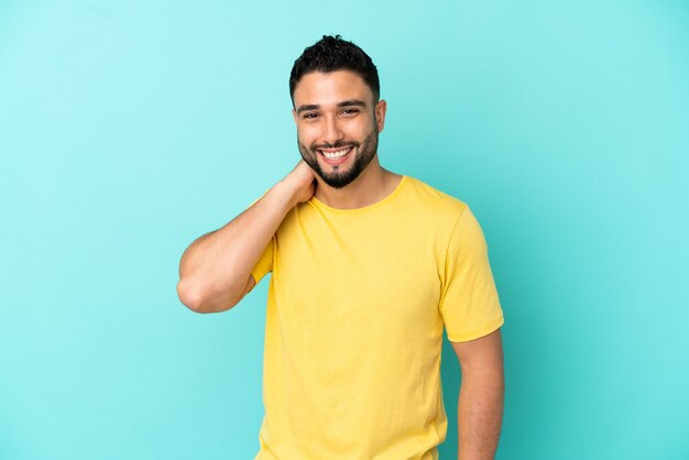 Young arab man isolated on blue background laughing