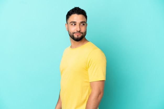 Young arab man isolated on blue background . Portrait