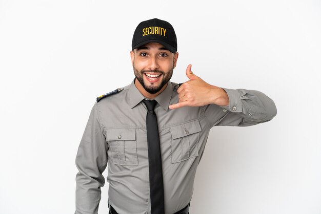 Young arab man isolated on white background making phone gesture. Call me back sign