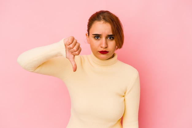 Foto giovane donna araba di razza mista che mostra un gesto di antipatia, i pollici verso il basso. concetto di disaccordo.