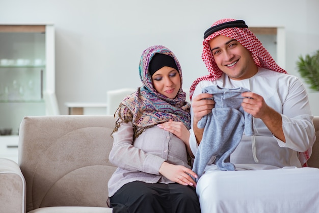 Young arab muslim family with pregnant wife expecting baby