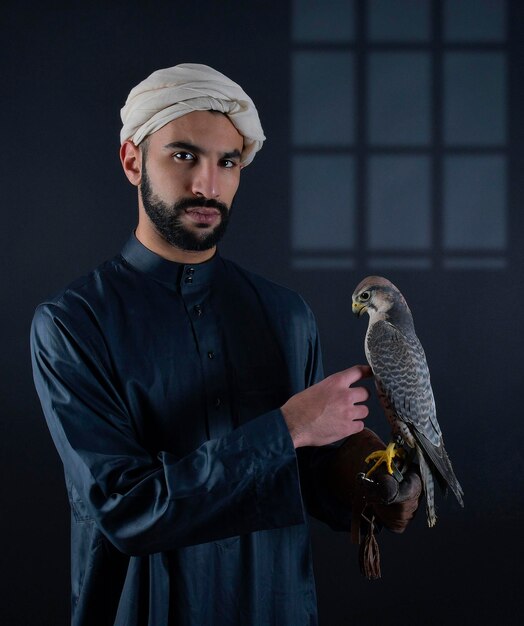 Young Arab prince holding a bird of prey. 