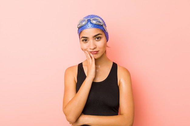 Young arab swimmer woman isolated who is bored, fatigued and needrelax day.