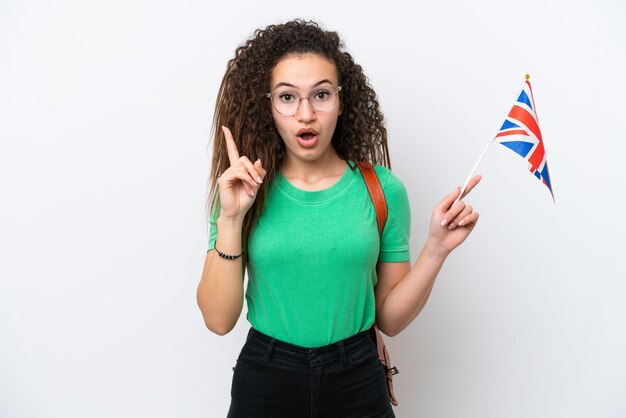 Young Arab woman holding an United Kingdom flag isolated on white background intending to realizes the solution while lifting a finger up