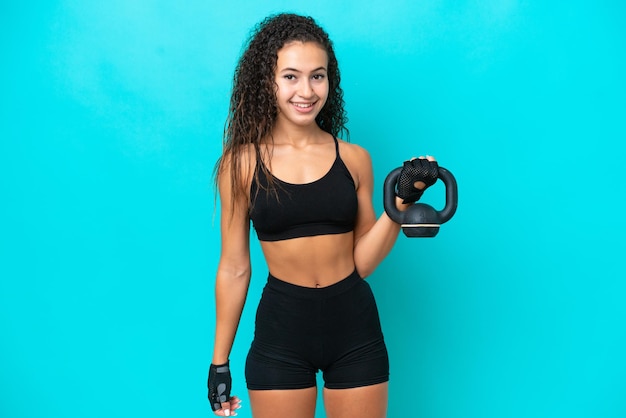 Young Arab woman isolated on blue background making weightlifting with kettlebell