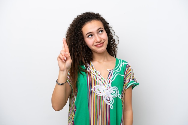 Young Arab woman isolated on white background with fingers crossing and wishing the best