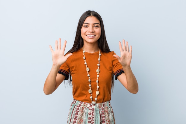 Young arab woman showing number ten with hands.