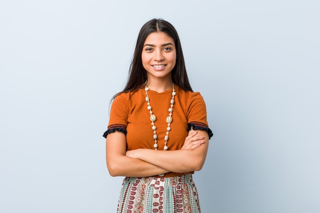 Young arab woman who feels confident, crossing arms with determination.