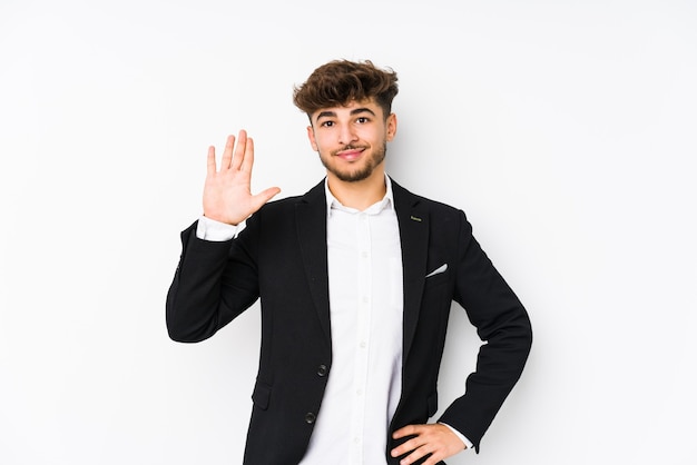 Young arabian business man isolated smiling cheerful showing number five with fingers.