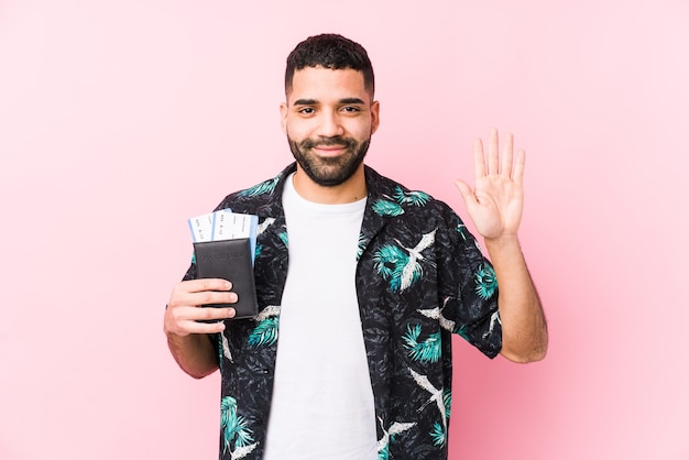 Young arabian cool man holding a boarding passes