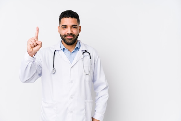 Young arabian doctor man isolated showing number one with finger.