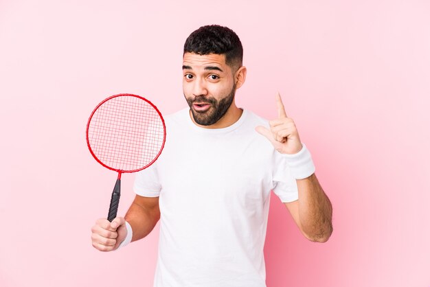 Young arabian man playing badminton having an idea