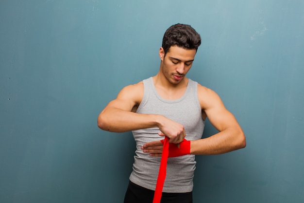 Young arabian man with boxing gloves. sport concept