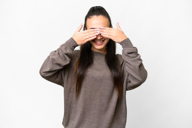 Young Arabian woman over isolated white background covering eyes by hands and smiling