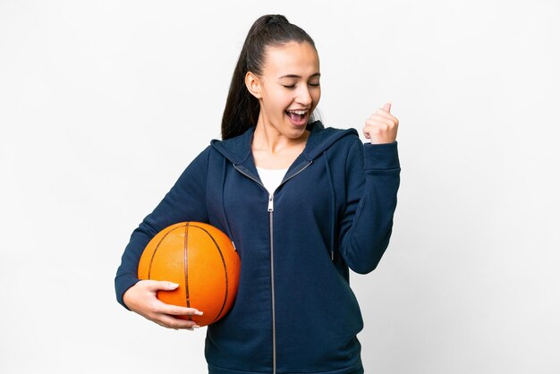 Young Arabian woman over isolated white background playing basketball