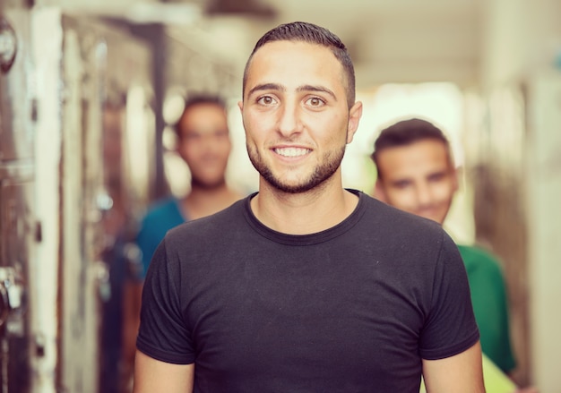 Young Arabic students in locker room at college