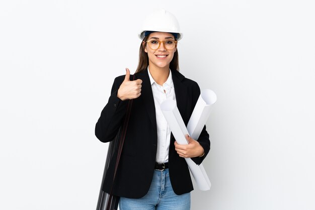 Young architect caucasian woman with helmet and holding blueprints