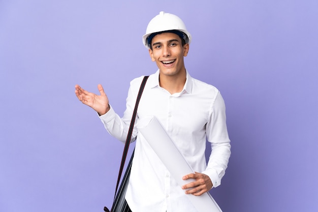 Young architect man isolated on background with shocked facial expression