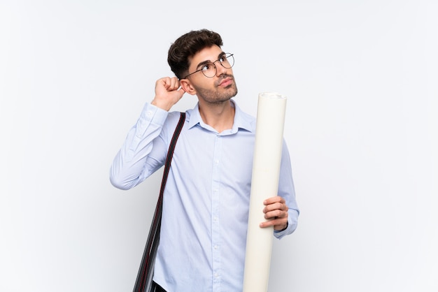 Young architect man over isolated white background having doubts and with confuse face expression