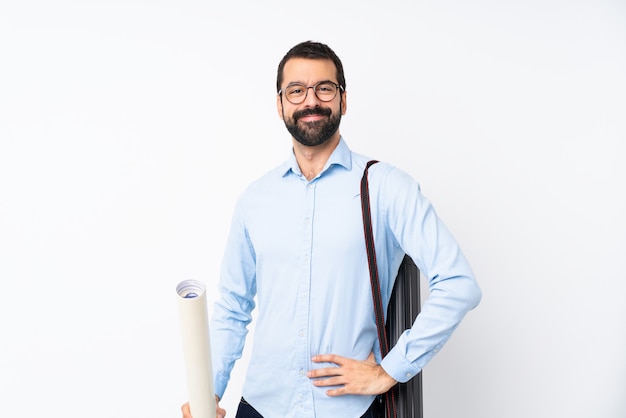 Young architect man with beard posing with arms at hip and smiling