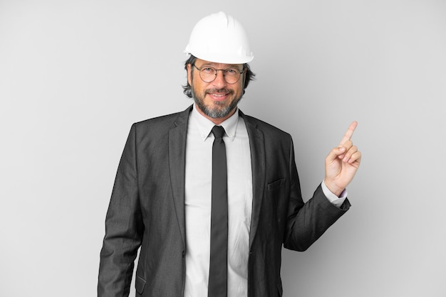 Young architect man with helmet over isolated background showing and lifting a finger in sign of the best