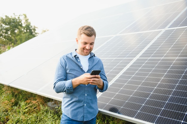 Young architect standing by solar panels