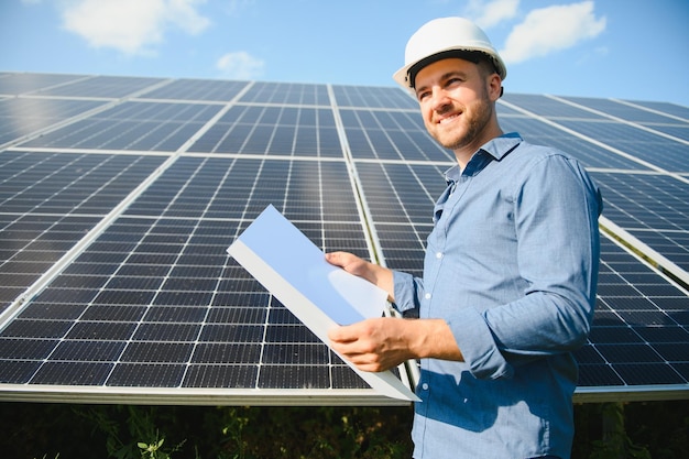 Young architect standing by solar panels