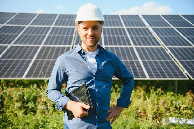 Young architect standing by solar panels