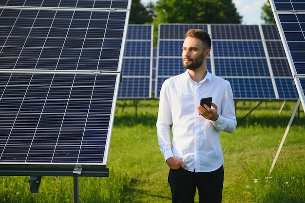 Young architect standing by solar panels