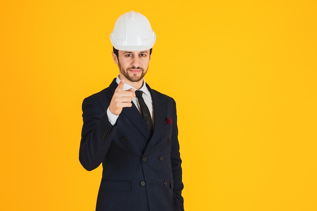 Young architect wearing glasses and safety helmet.