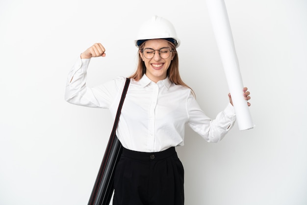 Young architect woman with helmet and holding blueprints isolated