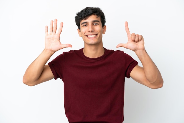 Young Argentinian man isolated on white background counting seven with fingers