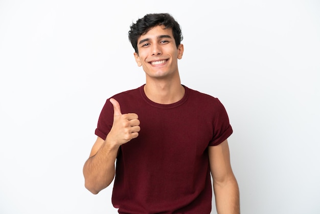 Young Argentinian man isolated on white background giving a thumbs up gesture