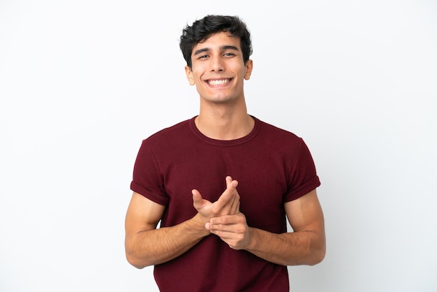 Young Argentinian man isolated on white background laughing