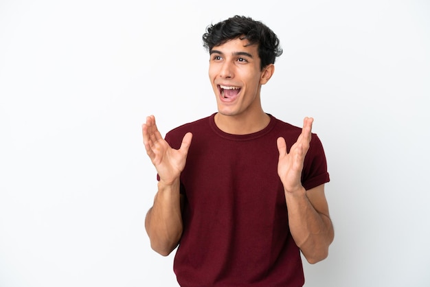 Young Argentinian man isolated on white background with surprise facial expression