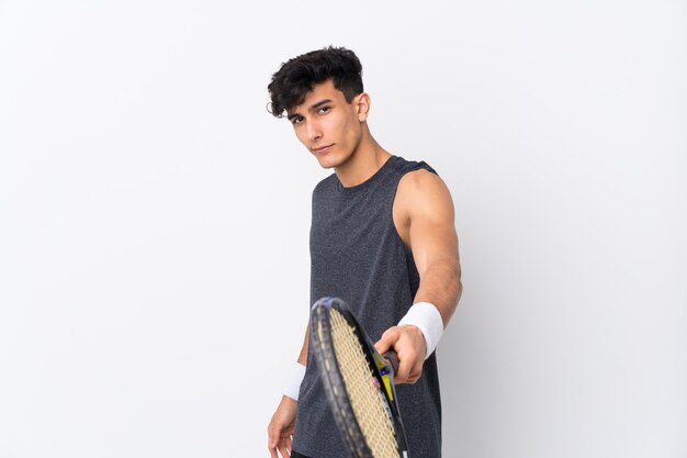 Young Argentinian man over isolated white wall playing tennis