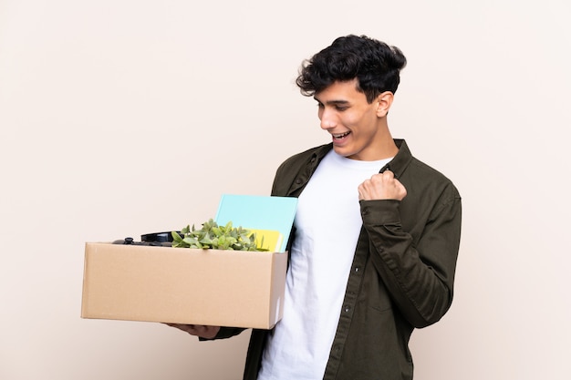 Young Argentinian man moving in new home over isolated celebrating a victory