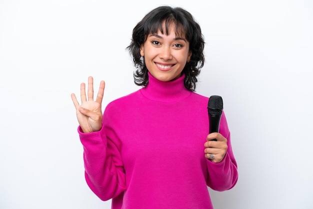 Young Argentinian singer woman isolated on white background happy and counting four with fingers