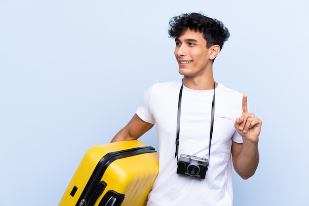 Young Argentinian traveller man intending to realizes the solution while lifting a finger up