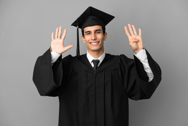 Young Argentinian university graduate isolated on grey background counting nine with fingers