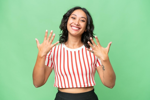 Young Argentinian woman over isolated background counting ten with fingers