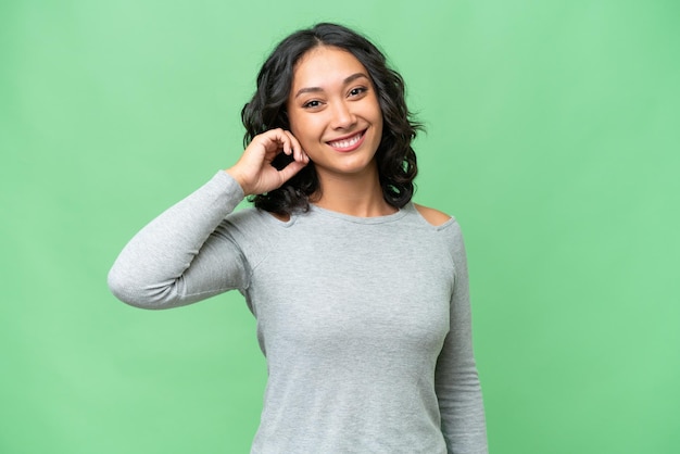 Young Argentinian woman over isolated background laughing