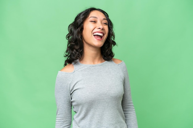 Young Argentinian woman over isolated background laughing