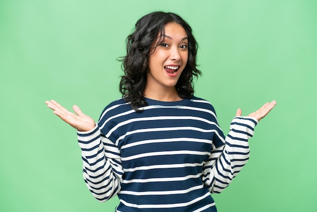 Young Argentinian woman over isolated background with shocked facial expression