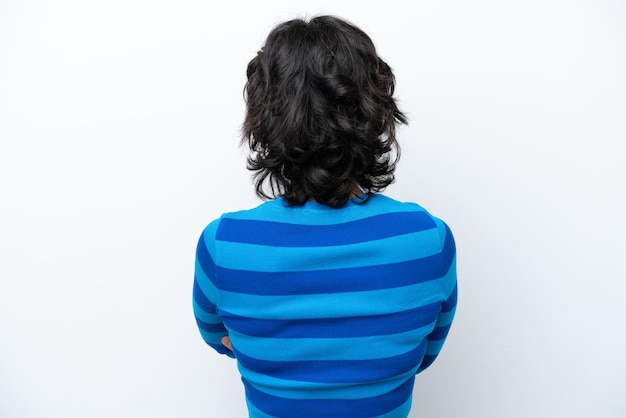 Young Argentinian woman isolated on white background in back position