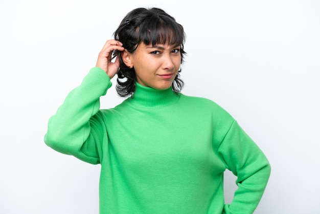 Young Argentinian woman isolated on white background having doubts