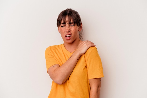 Young Argentinian woman isolated on white background having a shoulder pain.